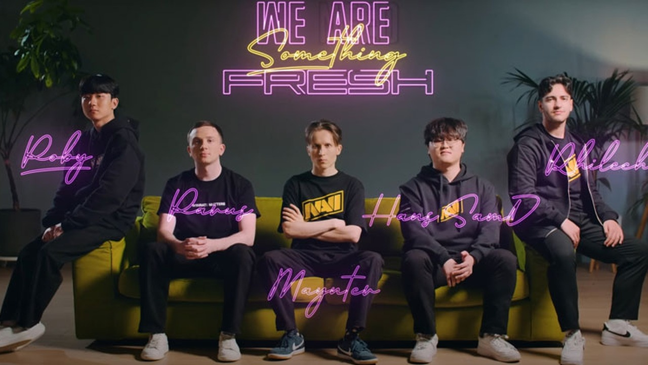 NAVI League of Legends players sit together in team clothing