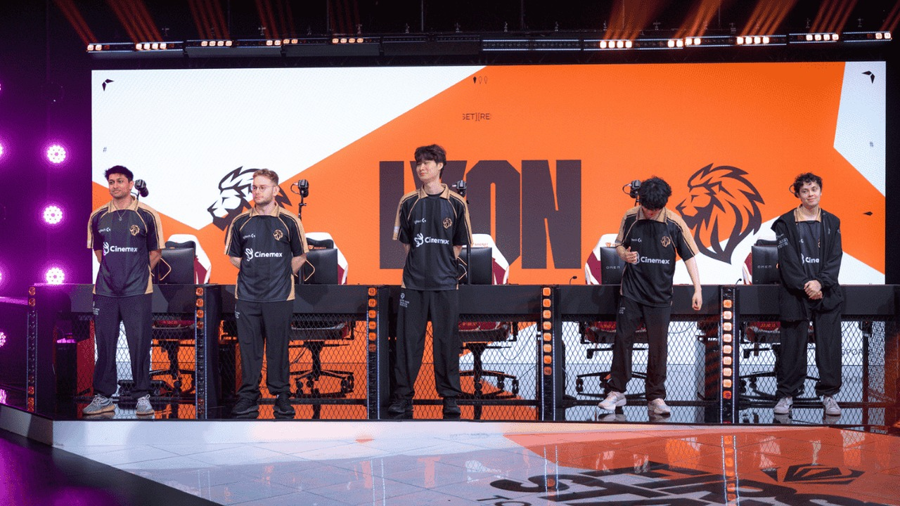 Five LYON League of Legends players stand at their stage desks