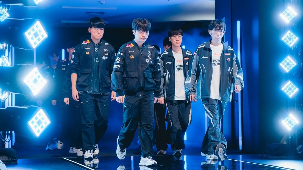 League of Legends players appear under blue stage lights