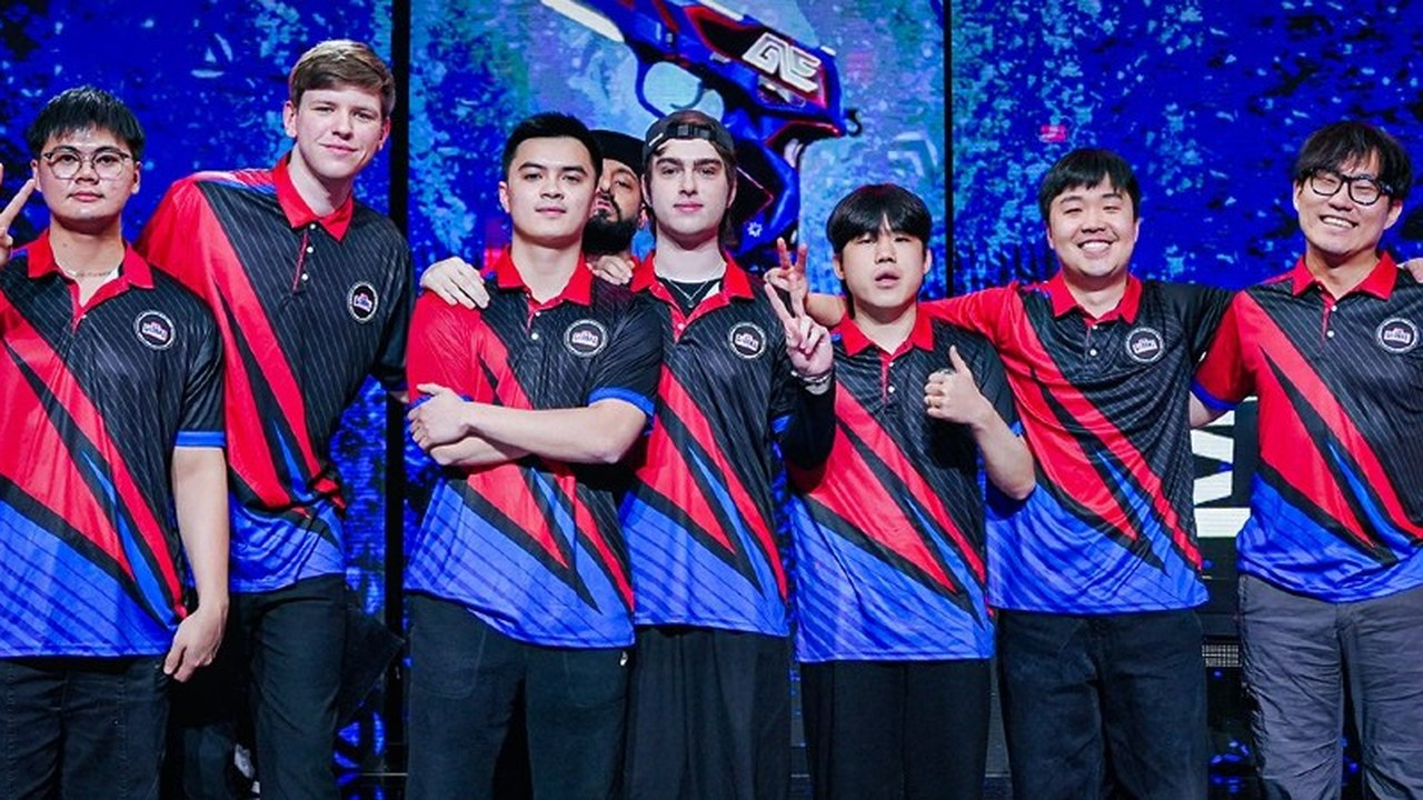 Global Esports players and staff pose together on a Valorant stage