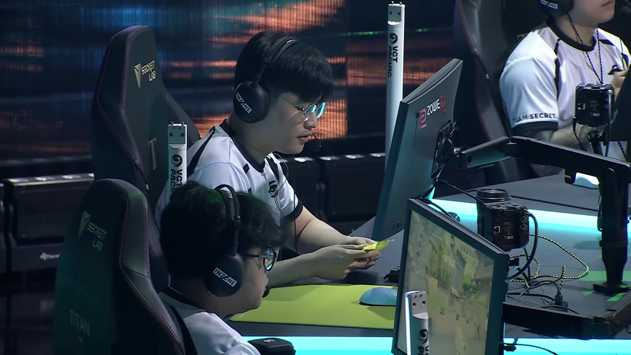 Team Secret players sit together on the Pacific Stage 2 broadcast