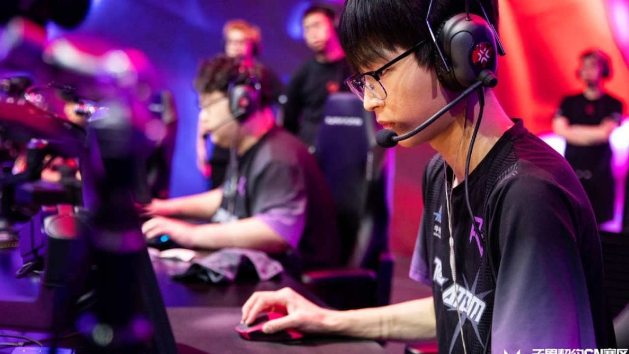 JDG Valorant players compete at their gaming desks