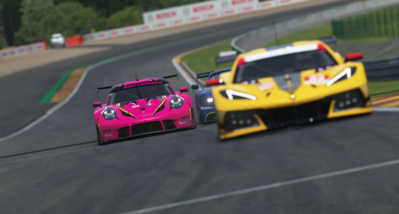 GT race cars battling through a corner in Le Mans Ultimate