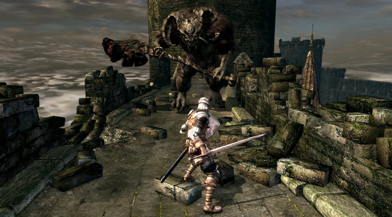 Knight facing a giant demon boss on a castle bridge in Dark Souls Remastered