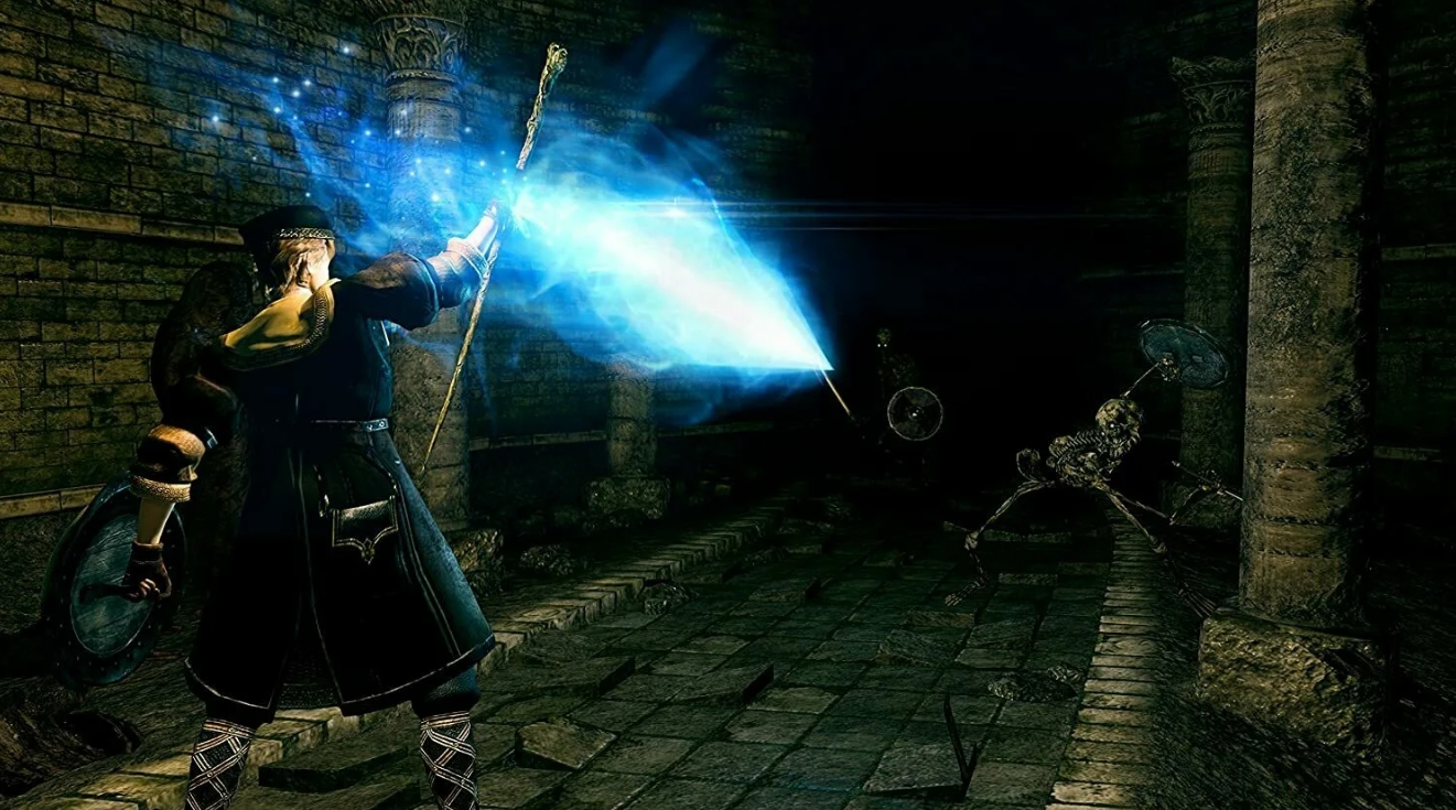 Mage casting a powerful blue magic spell at skeleton enemies in a dark dungeon in Dark Souls Remastered