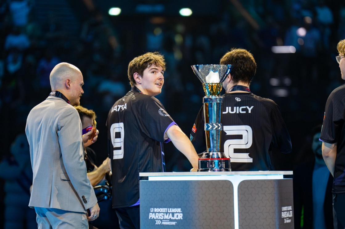 Karmine Corp players standing beside the Rocket League Paris Major 2026 trophy after winning the tournament