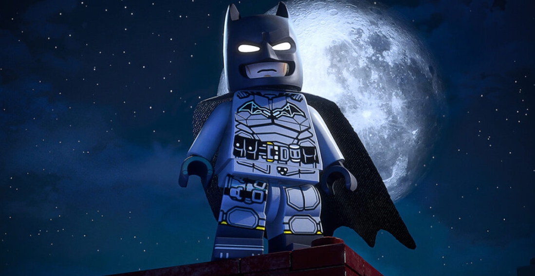 LEGO Batman standing on a rooftop under the moon in LEGO Batman Legacy of the Dark Knight