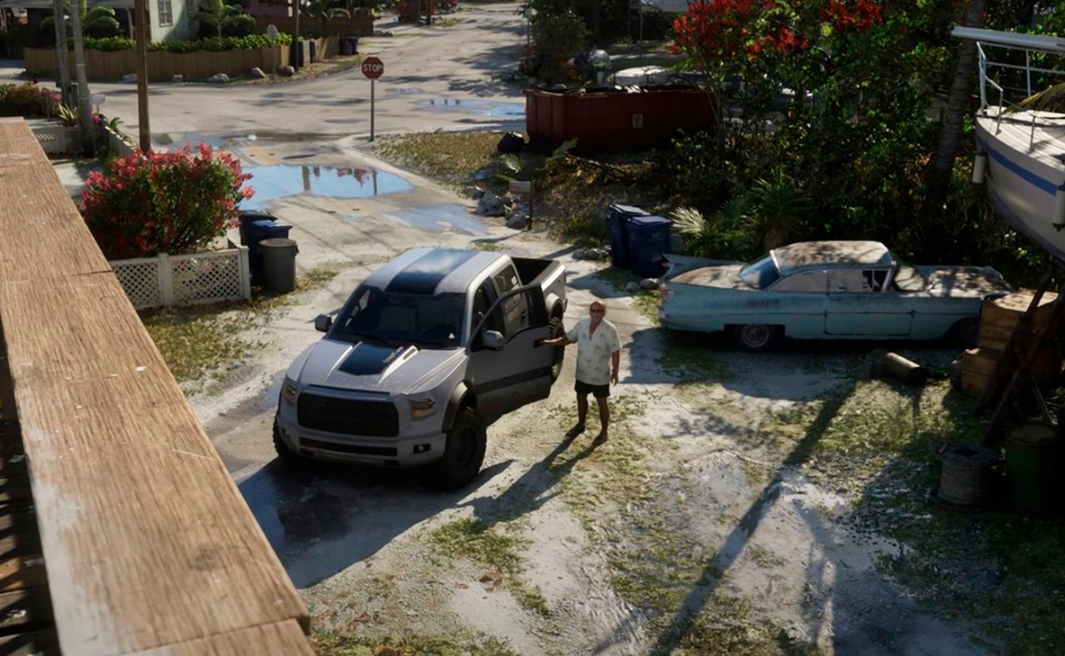 A Leonida resident stands beside a pickup truck in a neighborhood shown in the second GTA VI trailer