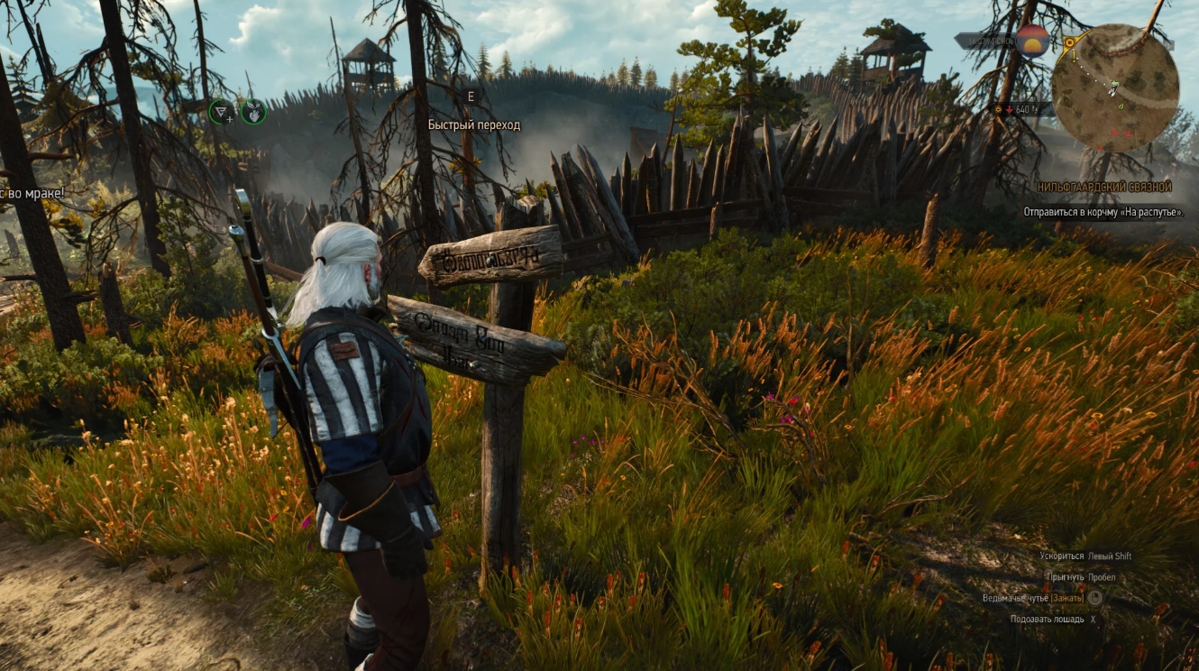 Geralt of Rivia standing near a signpost outside a fortified camp in The Witcher 3 next-gen update