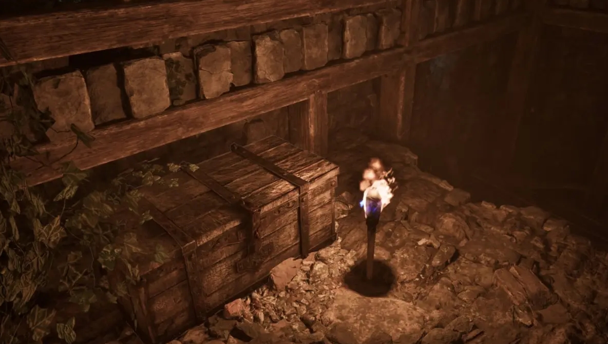 Treasure chest and torch in a dark cave from Gothic 1 Remake featuring the lockpicking puzzle system