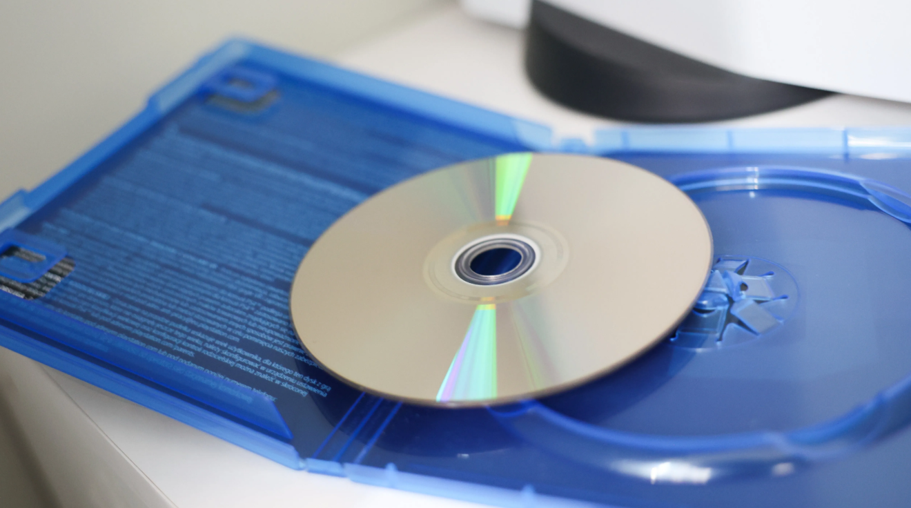 PlayStation game disc inside its case as Sony prepares to end physical game releases in 2028 and move to digital distribution for PS5 and future PS6