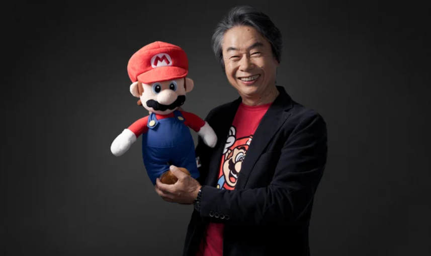 Shigeru Miyamoto holding a plush Mario toy — Nintendo creator discusses his philosophy of designing games without chasing market trends